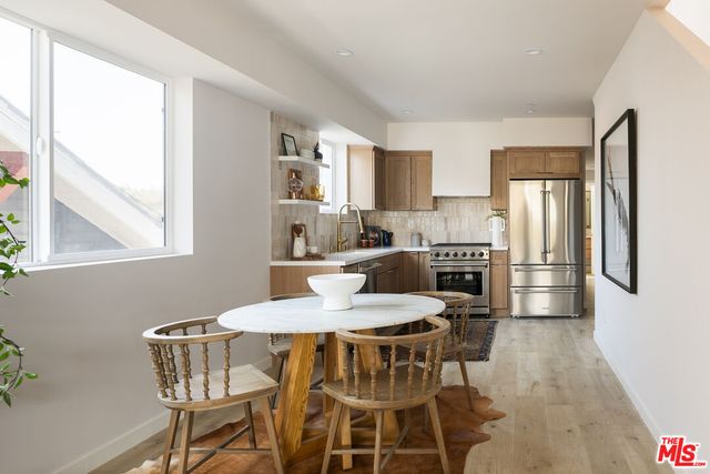 a dining room with furniture and window