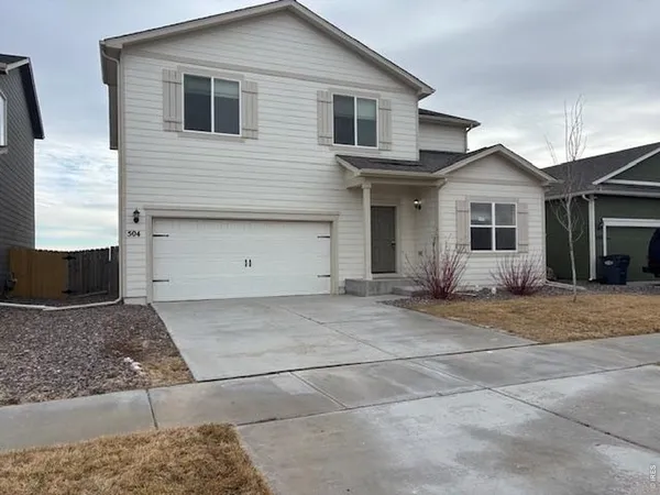 a view of a house with a yard and garage