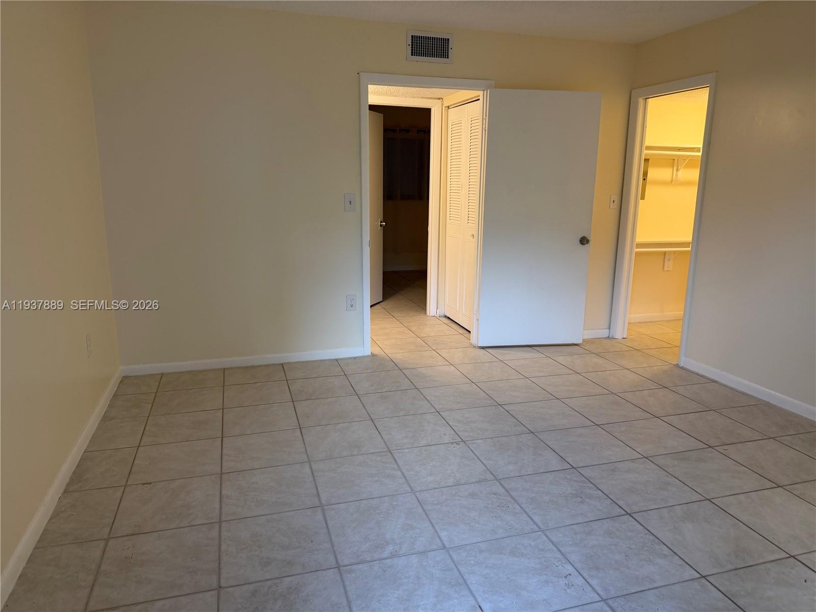 8500 Southwest 133rd Avenue Road, Unit 122 Miami, FL 33183 - Photo 11 of 22 an empty room with a natural light and carpet