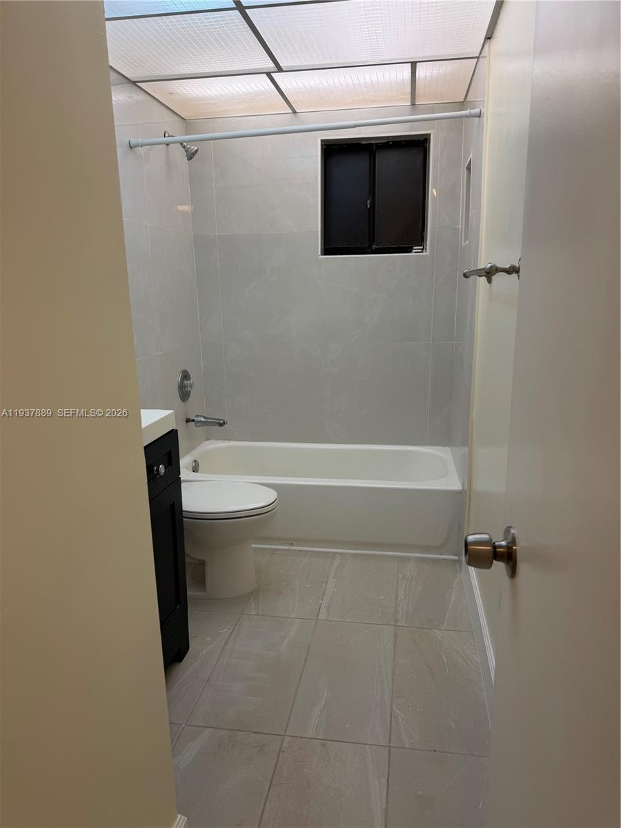 8500 Southwest 133rd Avenue Road, Unit 122 Miami, FL 33183 - Photo 13 of 22 a bathroom with a toilet and a shower
