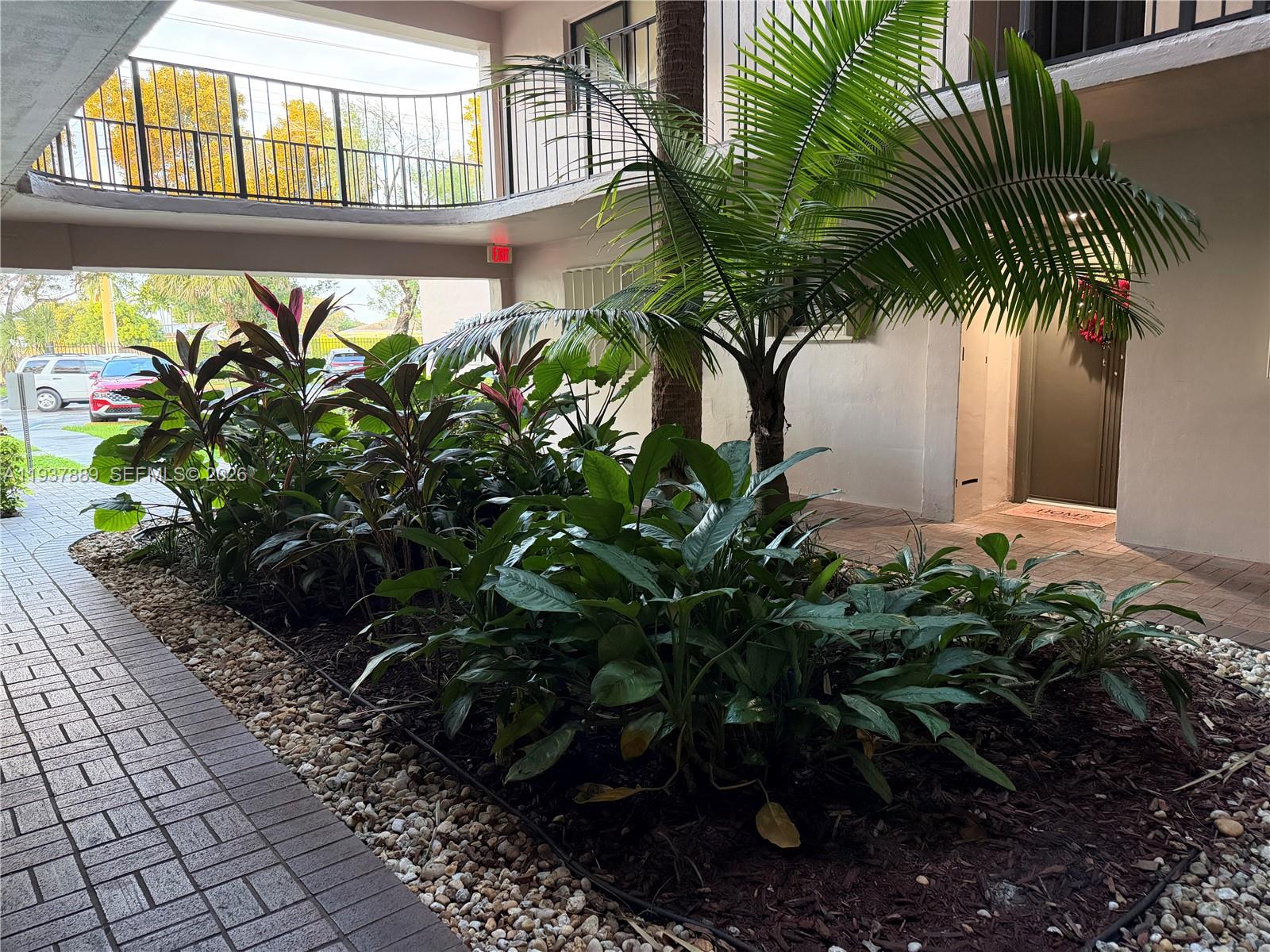 8500 Southwest 133rd Avenue Road, Unit 122 Miami, FL 33183 - Photo 5 of 22 a plant is in front of a house