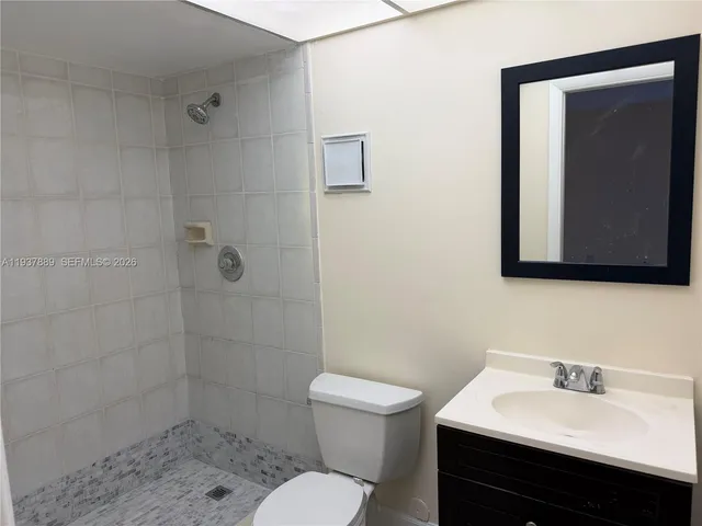 a bathroom with a sink a toilet and mirror