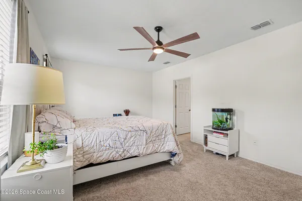 a bedroom with a bed and a couch