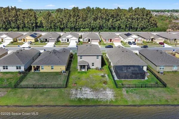 an aerial view of a house with outdoor space swimming pool