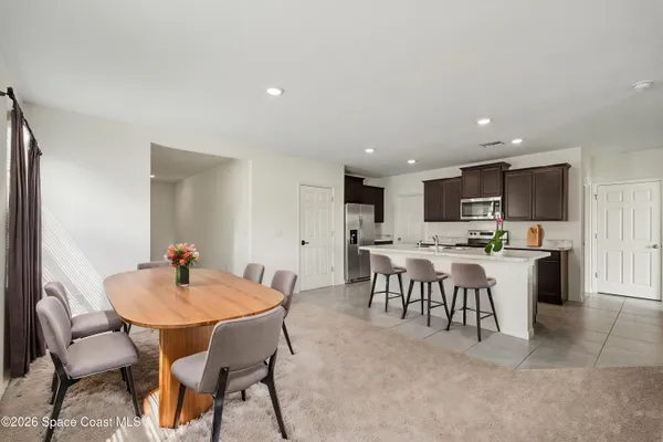 a kitchen with granite countertop a sink stainless steel appliances and cabinets