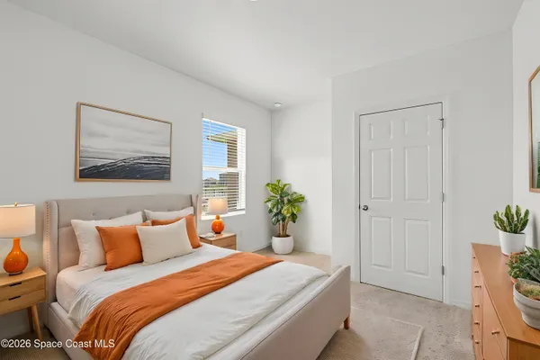 a bed room with a bed and a ceiling fan