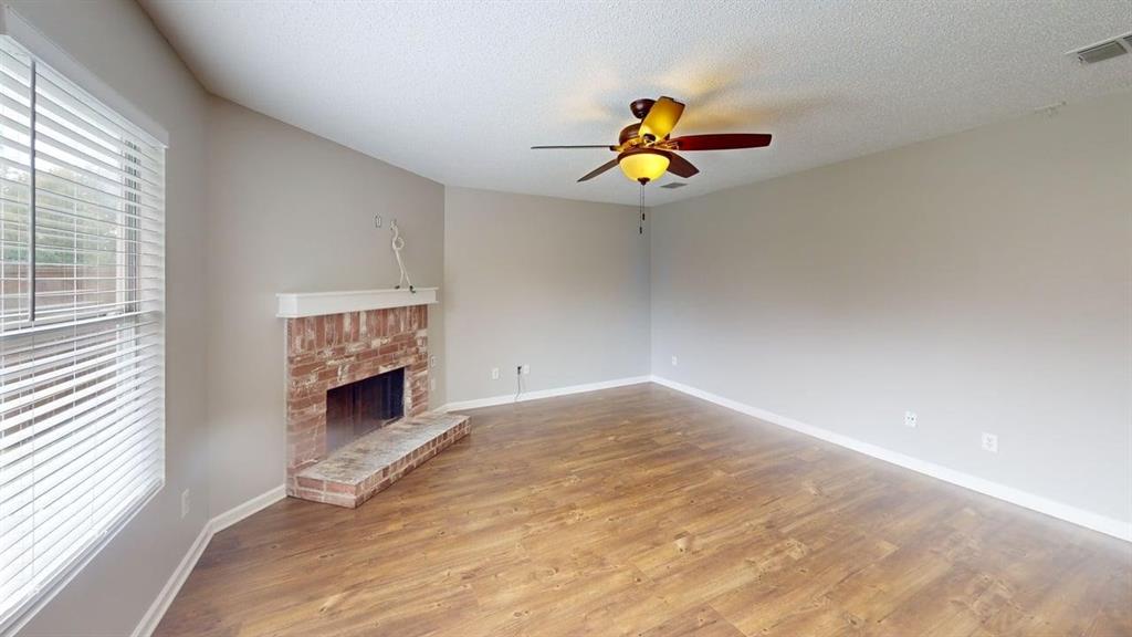 1505 Stewart Drive Rockwall, TX 75032 - Photo 6 of 20 a view of an empty room with a window and a ceiling fan