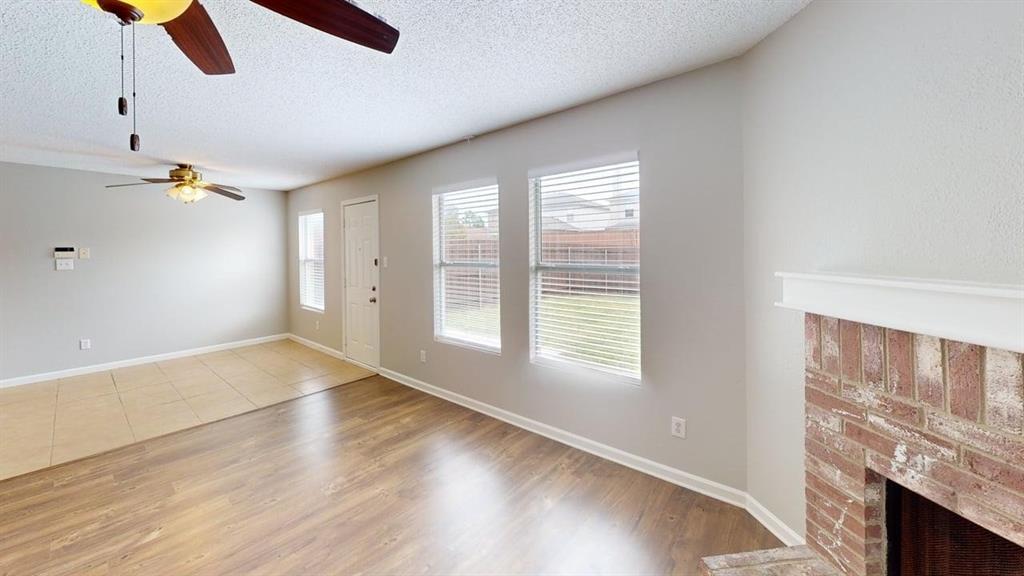 1505 Stewart Drive Rockwall, TX 75032 - Photo 7 of 20 a view of an empty room with window and wooden floor