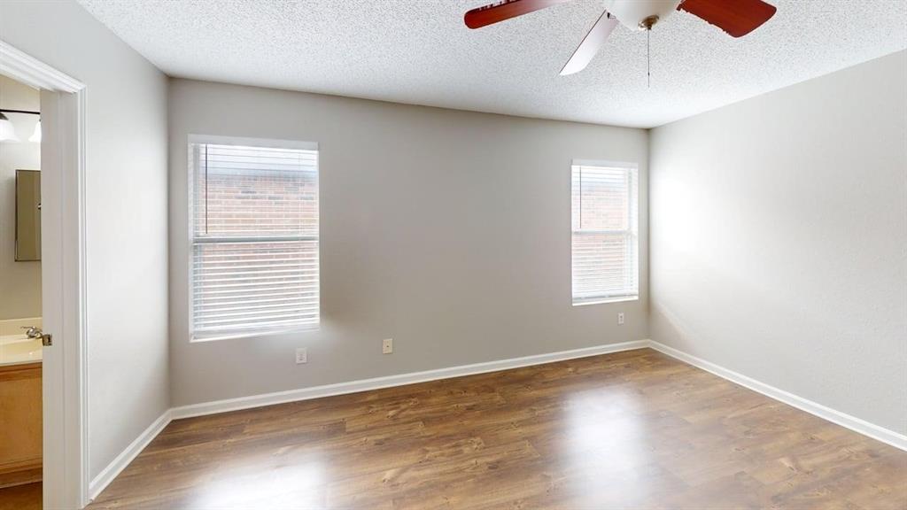 1505 Stewart Drive Rockwall, TX 75032 - Photo 10 of 20 an empty room with a window and wooden floor