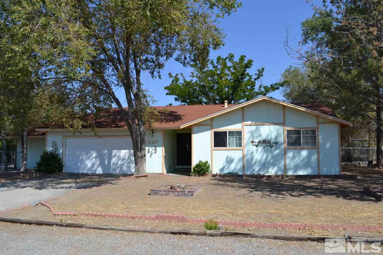127 Ring Road Dayton, NV 89403 - Photo 1 of 24 a front view of a house with a yard and garage