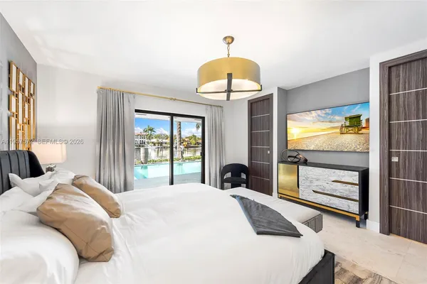 a bedroom with a bed and a chandelier