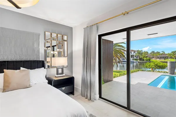 a bedroom with a balcony a bed and a view of balcony