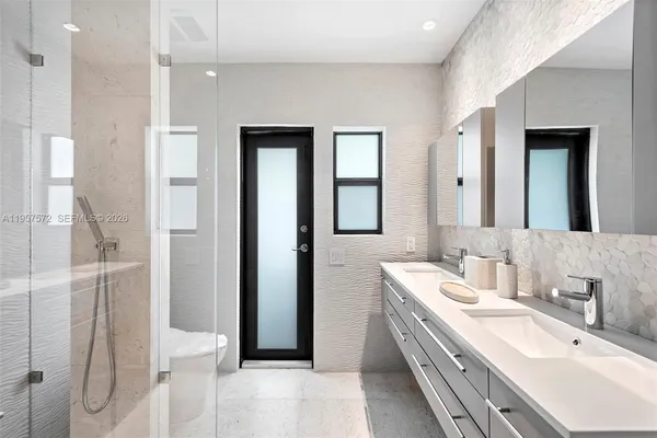 a bathroom with a double vanity sink mirror and double