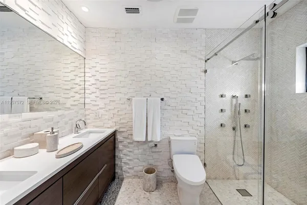 a bathroom with a sink toilet and shower