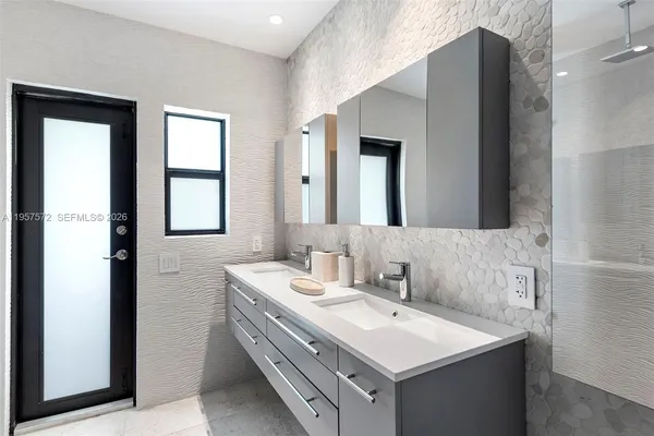 a bathroom with a sink and a mirror