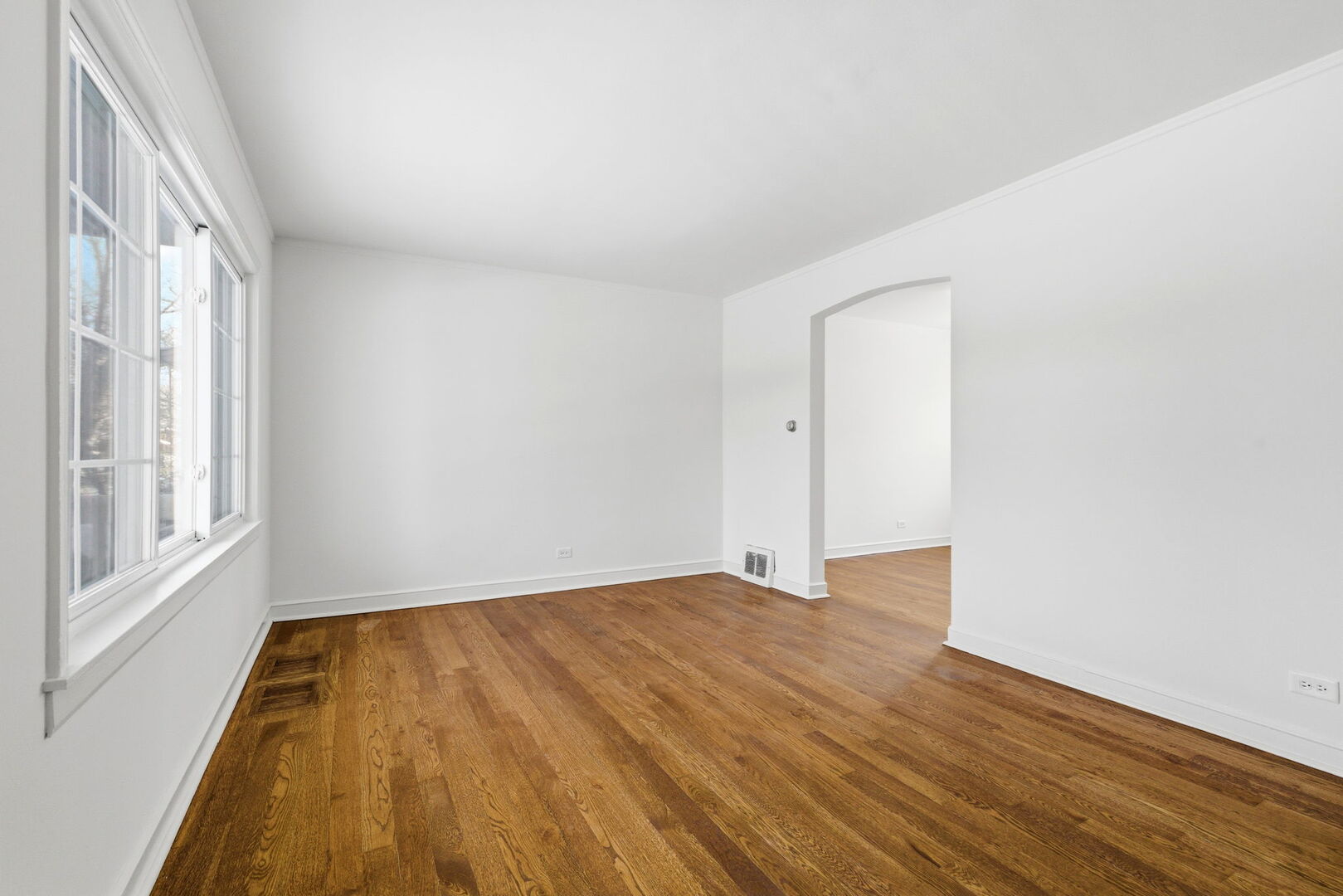 10344 South Albany Avenue Chicago, IL 60655 - Photo 2 of 17 a view of empty room with wooden floor and fan