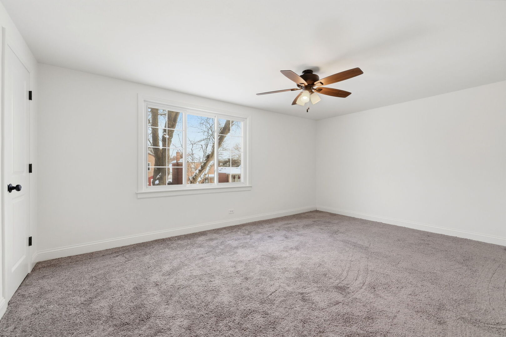 10344 South Albany Avenue Chicago, IL 60655 - Photo 10 of 17 an empty room with windows and chandelier fan
