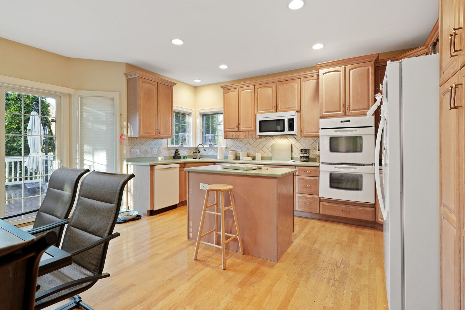 40388 Reed Court Wadsworth, IL 60083 - Photo 20 of 30 a kitchen with stainless steel appliances granite countertop a stove a sink a microwave and a refrigerator
