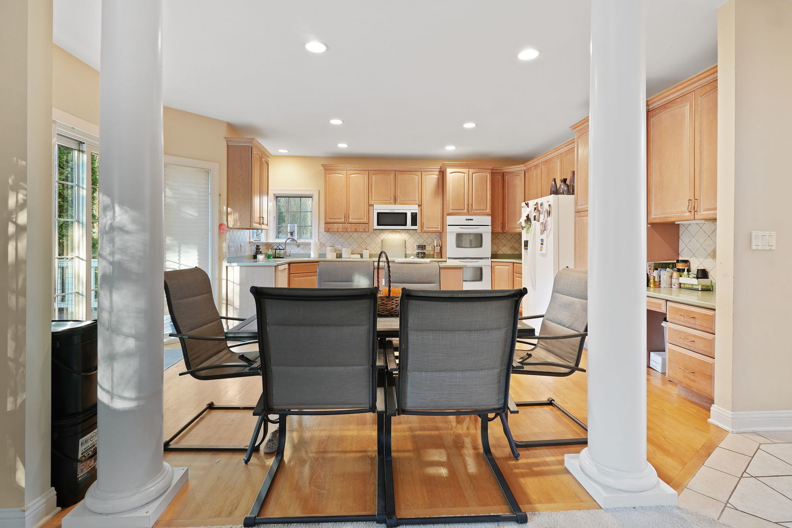 40388 Reed Court Wadsworth, IL 60083 - Photo 7 of 30 a dining room with stainless steel appliances kitchen island granite countertop a table and chairs