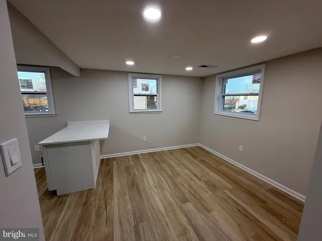 a view of room with window and hardwood floor