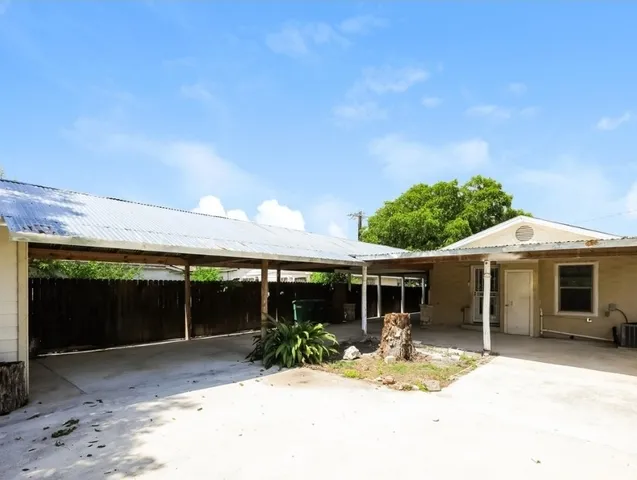 a view of a patio with table and chairs under an umbrella