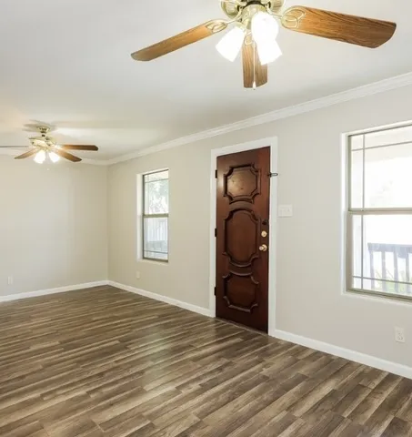 wooden floor in an empty room with a window