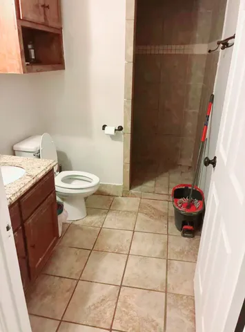 a bathroom with a toilet and a shower