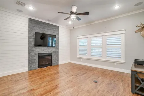 a view of an empty room with a fireplace and a window