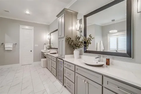 a spacious bathroom with a granite countertop sink a mirror and a
