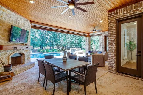 a living room with furniture a fireplace and a floor to ceiling window