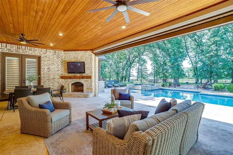 a view of swimming pool with outdoor seating and plants