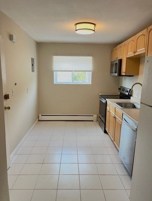 22 Westgate Road, Unit 3 Boston, MA 02467 - Photo 5 of 18 a view of a kitchen with a sink dryer and washer