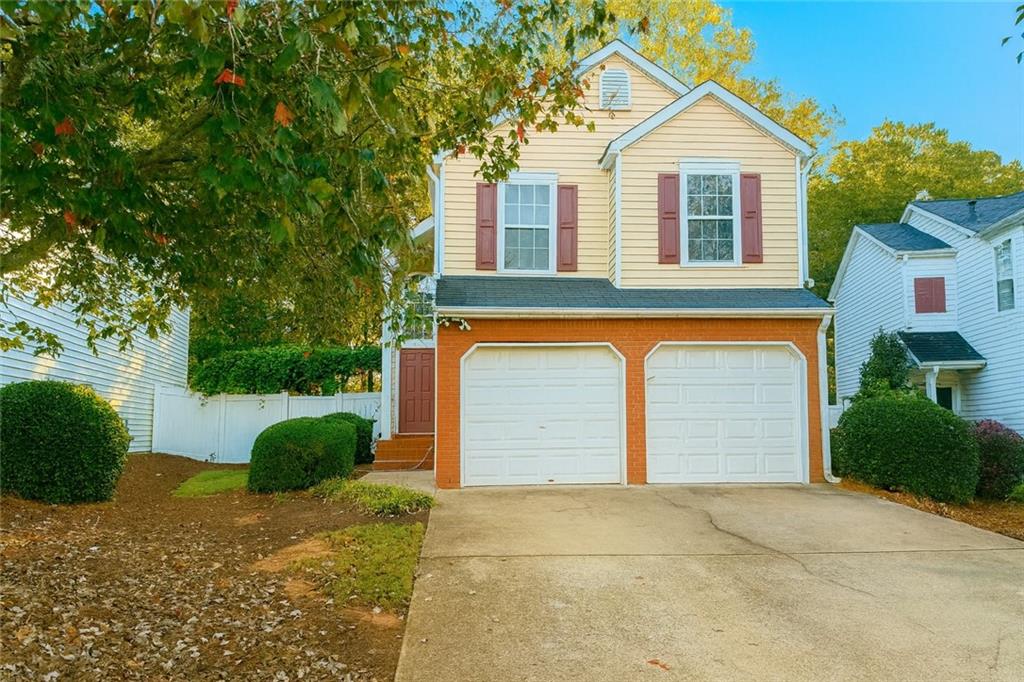 1070 Daventry Crossing Woodstock, GA 30188 - Photo 1 of 20 a front view of a house with a yard and garage