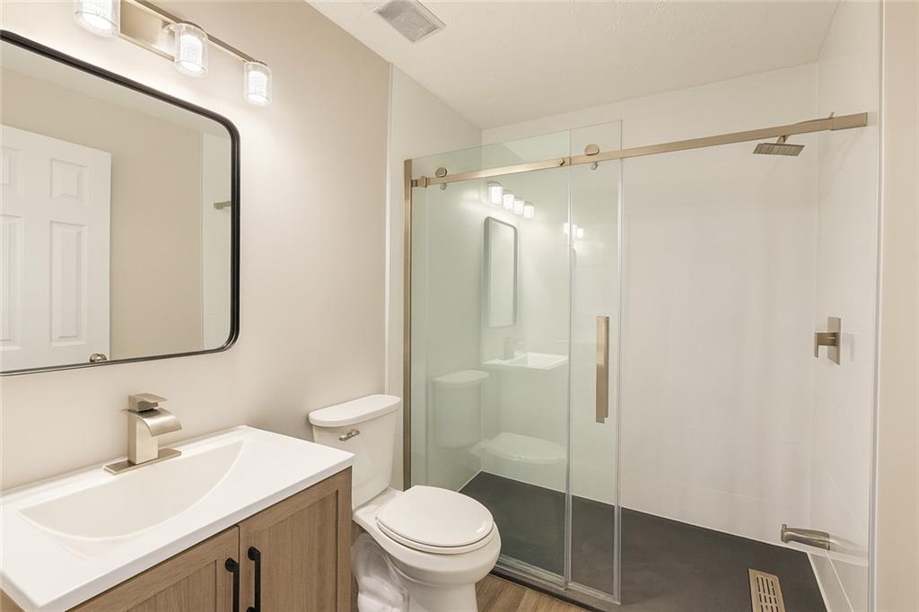 1070 Daventry Crossing Woodstock, GA 30188 - Photo 12 of 20 a bathroom with a sink vanity mirror and toilet