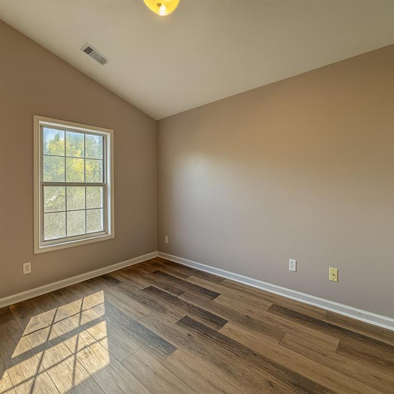 1070 Daventry Crossing Woodstock, GA 30188 - Photo 13 of 20 an empty room with wooden floor and windows