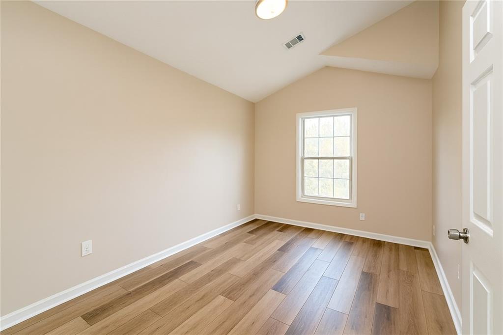 1070 Daventry Crossing Woodstock, GA 30188 - Photo 14 of 20 an empty room with wooden floor and windows