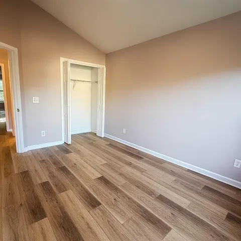 a view of a room with wooden floor and closet