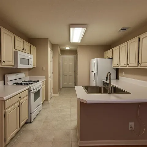 a kitchen with stainless steel appliances granite countertop a sink stove and cabinets