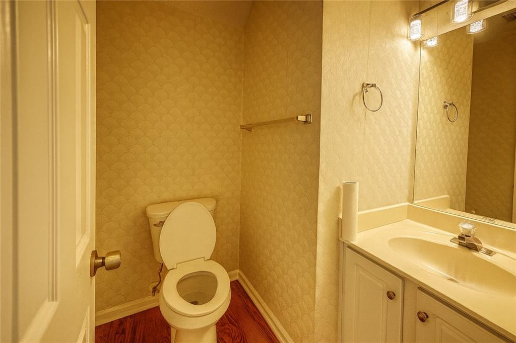 1070 Daventry Crossing Woodstock, GA 30188 - Photo 7 of 20 a bathroom with a granite countertop toilet and a sink