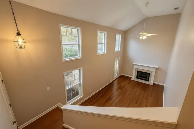 a room with wooden floor and fireplace