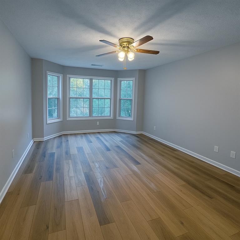 1070 Daventry Crossing Woodstock, GA 30188 - Photo 9 of 20 a view of an empty room with wooden floor and a window