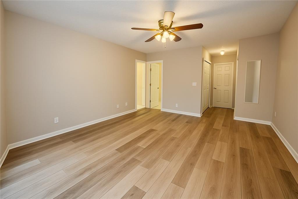 1070 Daventry Crossing Woodstock, GA 30188 - Photo 10 of 20 a view of a big room with wooden floor and a ceiling fan