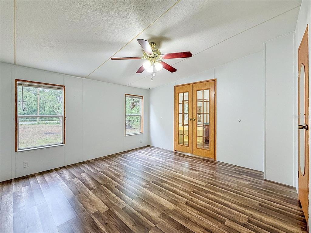 1819 Sinclair Hills Road Lutz, FL 33549 - Photo 33 of 60 a view of an empty room with window and wooden floor