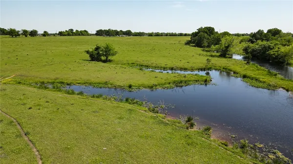 a view of a lake with houses in the back