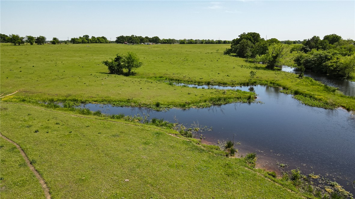 2587 JOLENE Trail Bryan, TX 77808 - Photo 4 of 7 a view of a lake with houses in the back