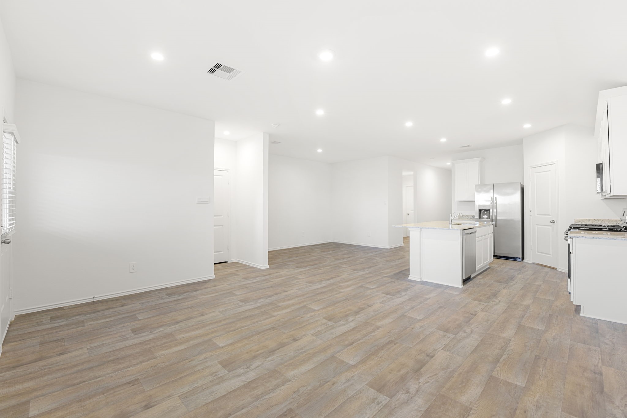 30906 Rockstock Road Fulshear, TX 77441 - Photo 18 of 43 a view of a kitchen with a sink and a refrigerator