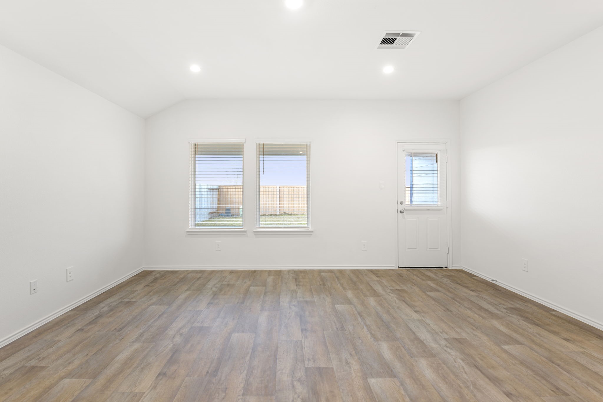 30906 Rockstock Road Fulshear, TX 77441 - Photo 21 of 43 an empty room with wooden floor and windows