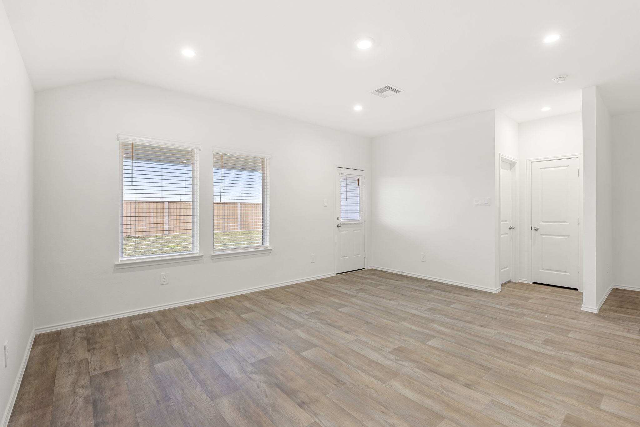 30906 Rockstock Road Fulshear, TX 77441 - Photo 22 of 43 an empty room with wooden floor and windows