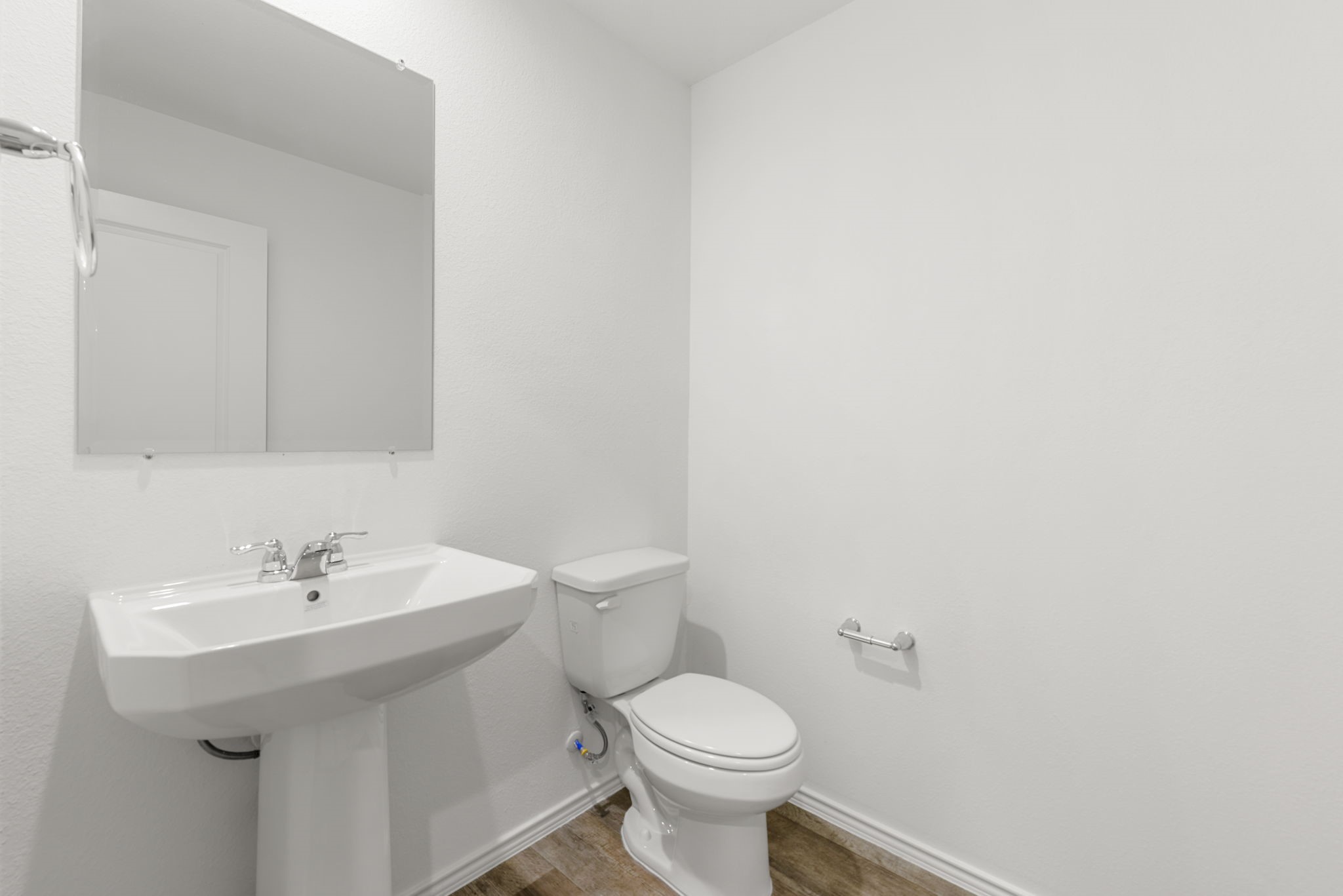 30906 Rockstock Road Fulshear, TX 77441 - Photo 31 of 43 a white toilet sitting next to a bathroom sink