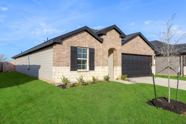 a front view of a house with a yard and fence